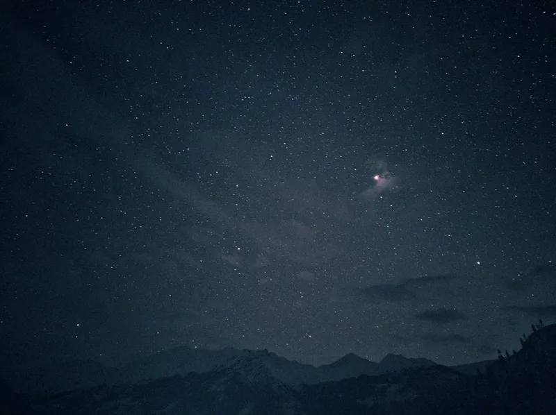 Stars above snow capped hills in Tosh, Himachal Pradesh